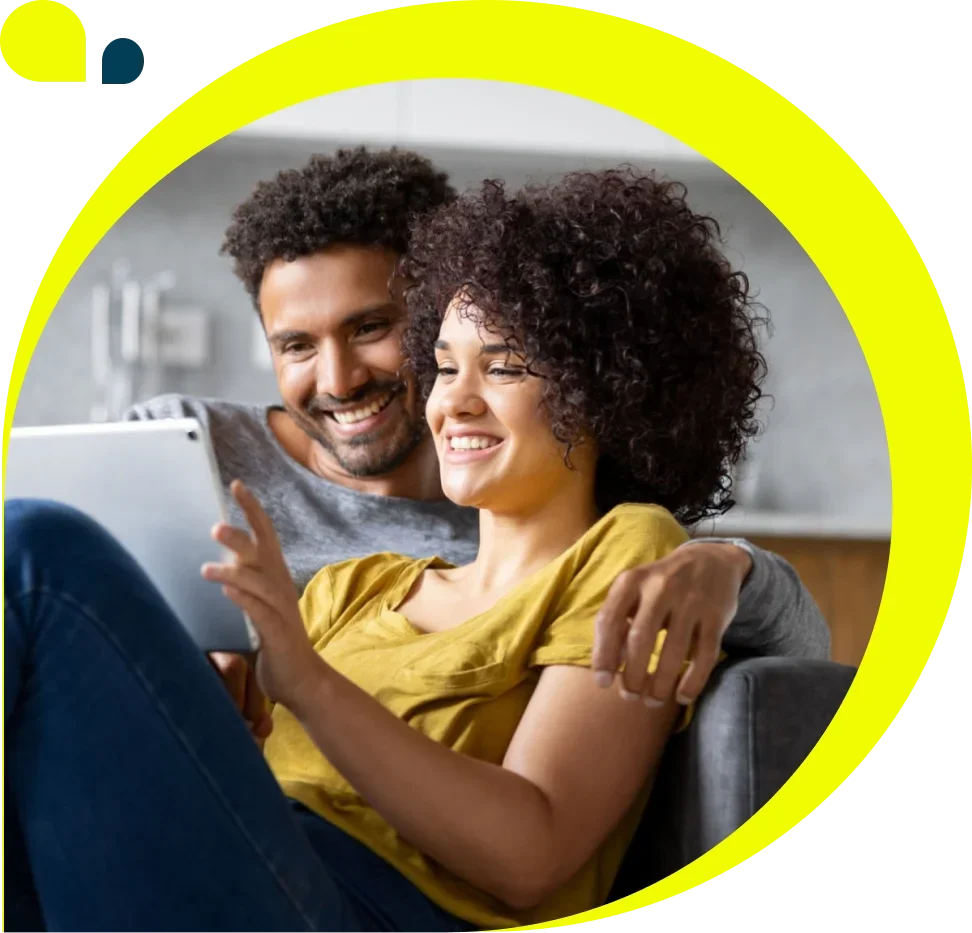 Man and woman on couch looking at tablet